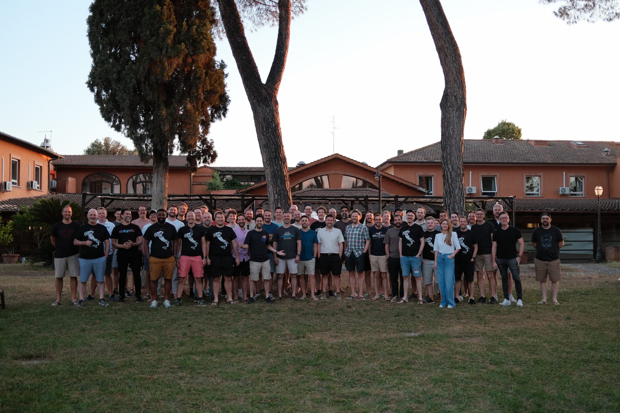 A group photo of all Flat Camp attendees in the yard in front of a pavillon